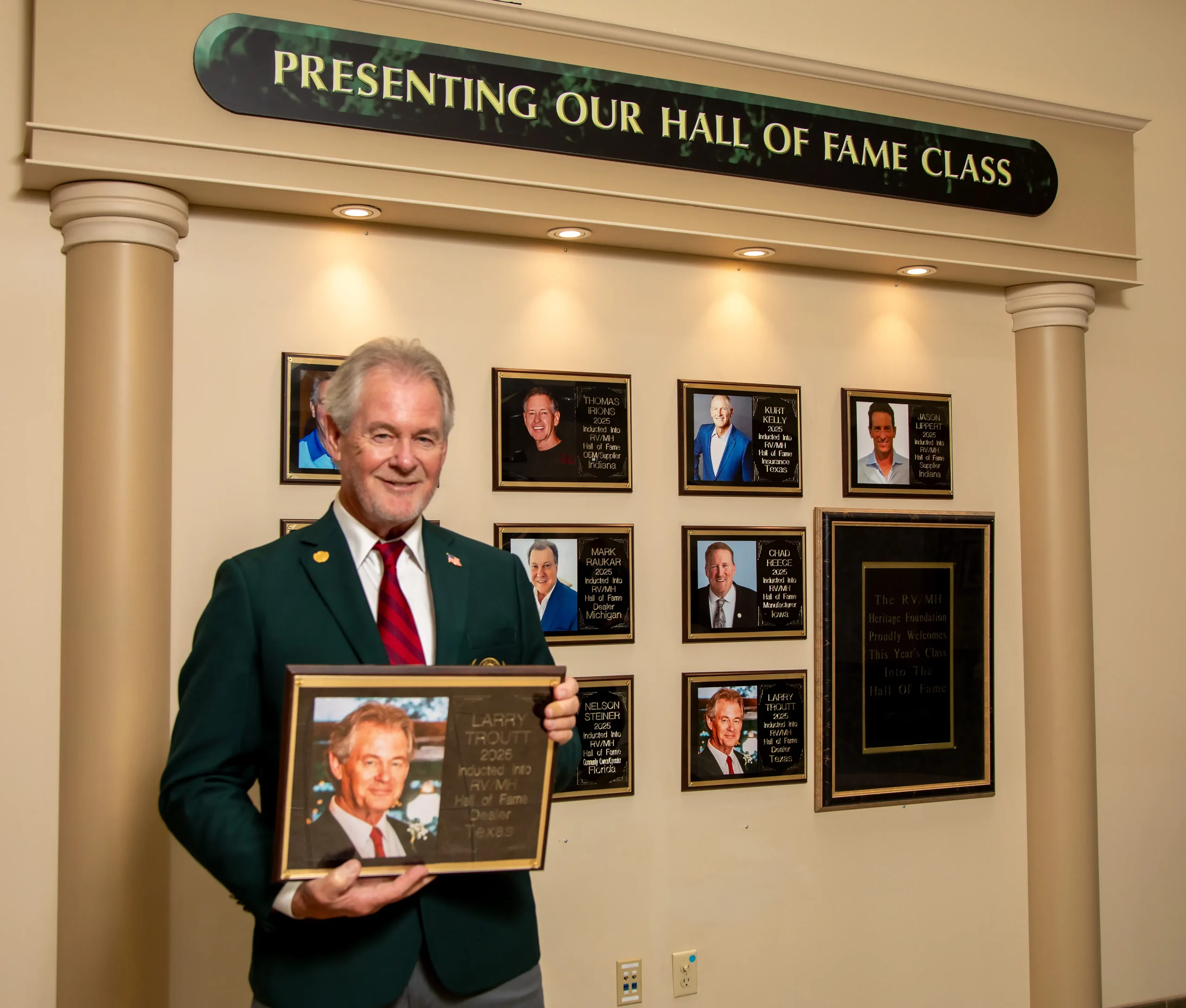 An actual Hall of Fame inductee wearing the Heritage Green jacket in front of the Hall of Fame class display.