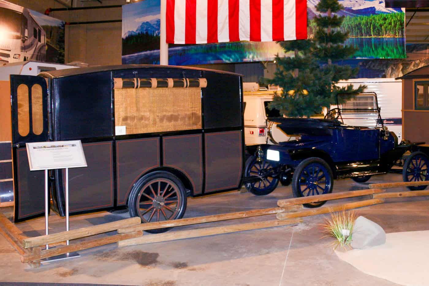 Early 20th-century Model T motorhome with a vintage blue Ford Model T tow vehicle