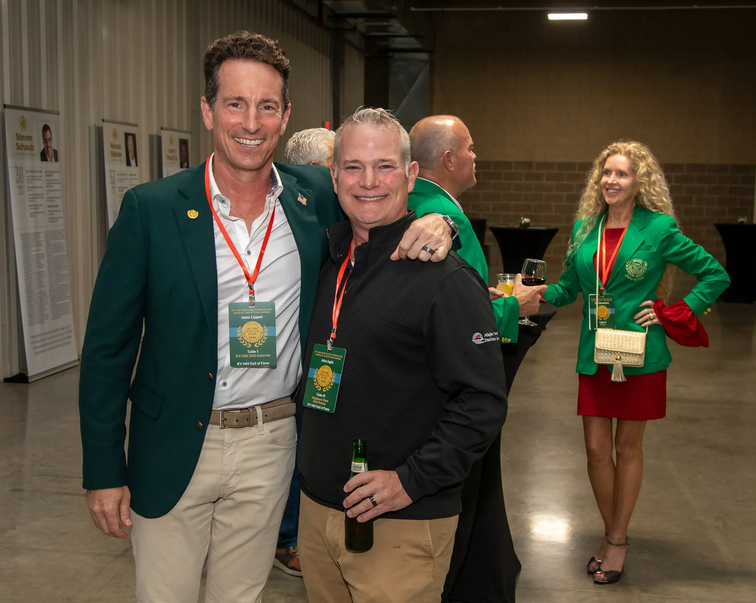 Hall of Fame guests and inductees gathered inside the museum with authentic Heritage Green jackets on display.