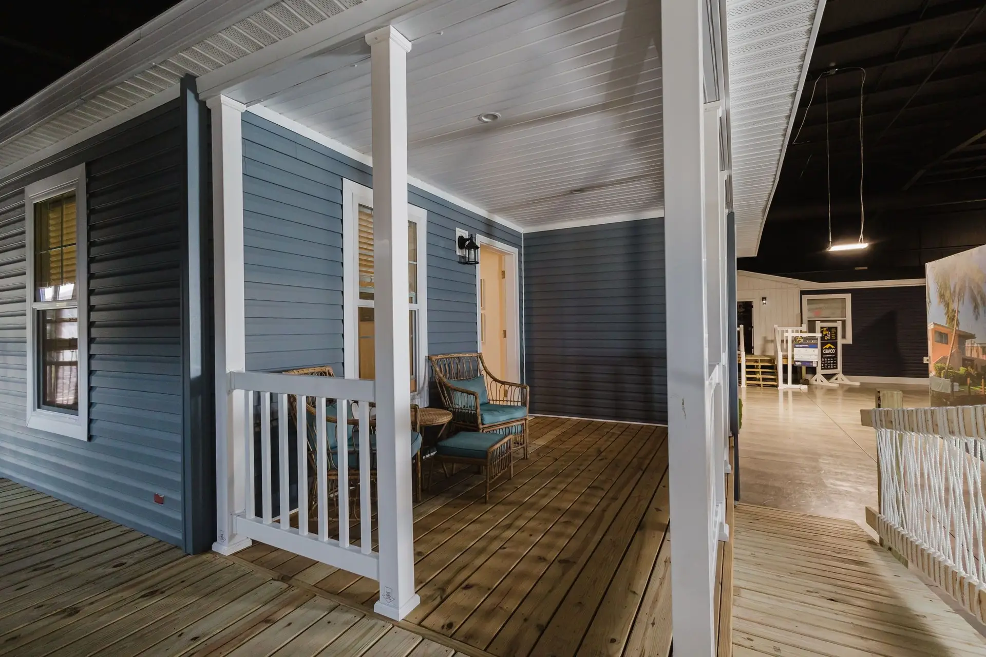 A museum exhibit featuring a life-sized replica of a manufactured home porch, showcasing the transition to residential aesthetics.