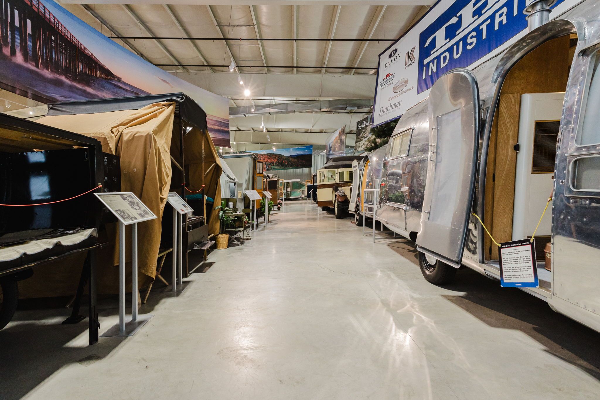 Interior view of the RV/MH Hall of Fame Museum, showcasing a row of vintage campers