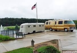 Vintage RVs beside the heritage fountain at the RV/MH Hall of Fame grounds in Elkhart, Indiana.